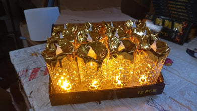 Collection of gold LED candles in various sizes, ideal for enhancing table settings and creating ambiance.